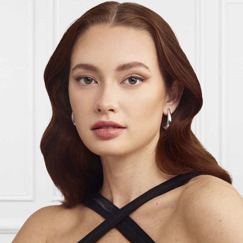 L'Oreal Paris Infallible 24H Face Sculptor Contour Woman with styled hair wearing a black top against a white background