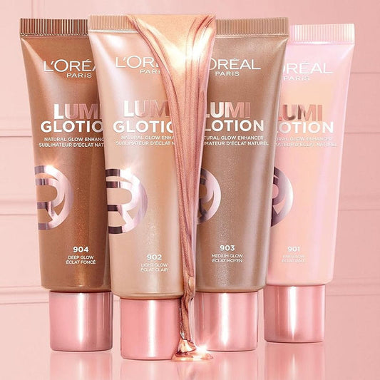 Four L'Oreal Lumiglotion tubes in different shades on a pink background
