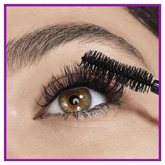 Close-up of an eye with mascara being applied, with a purple border.